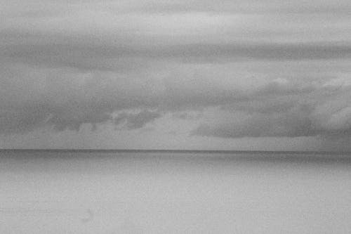 Grayscale Photo of Clouds over the Sea