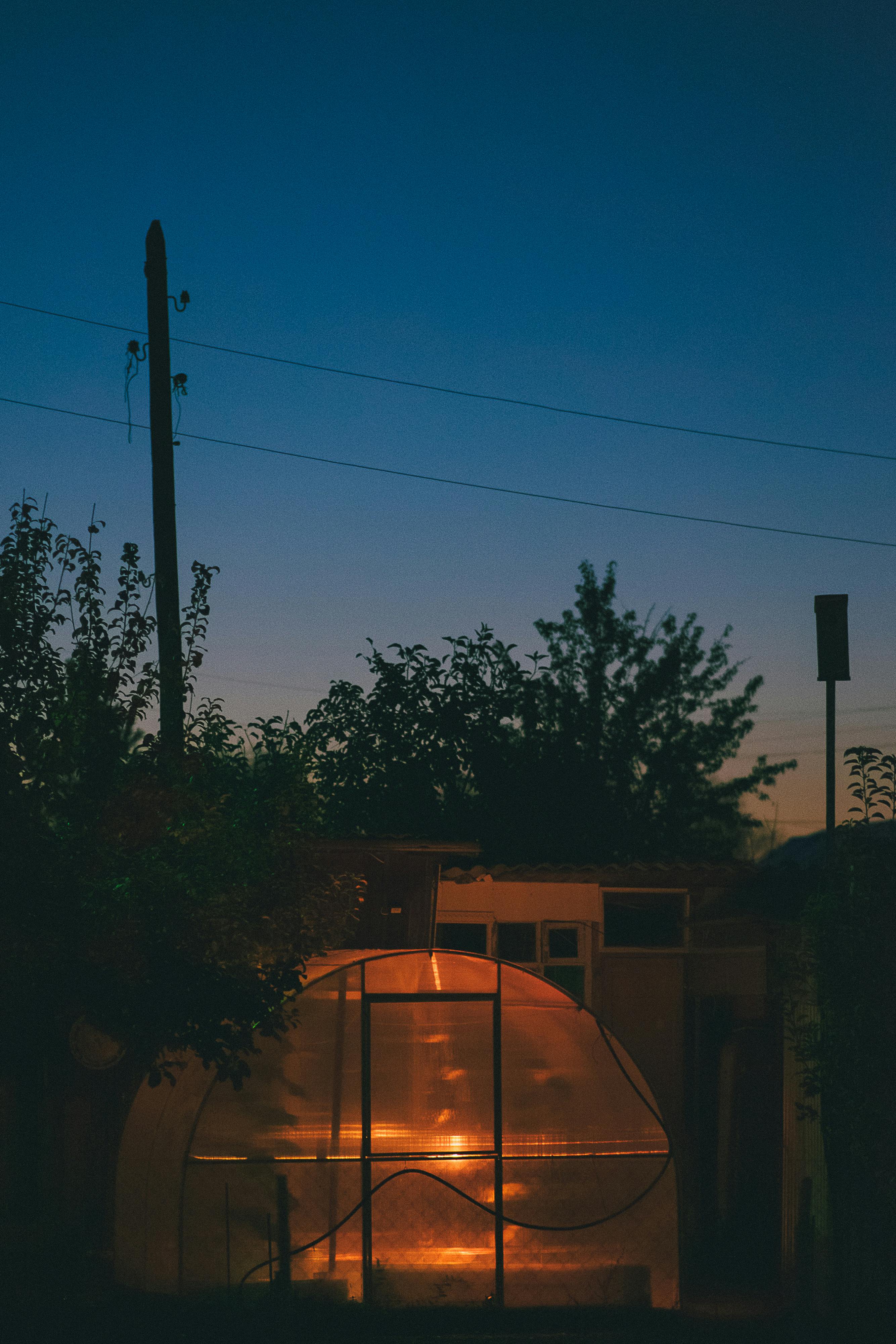 illuminated geenhouse at dusk