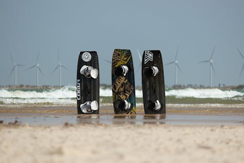 Wind Turbines and Surfboards on Beach