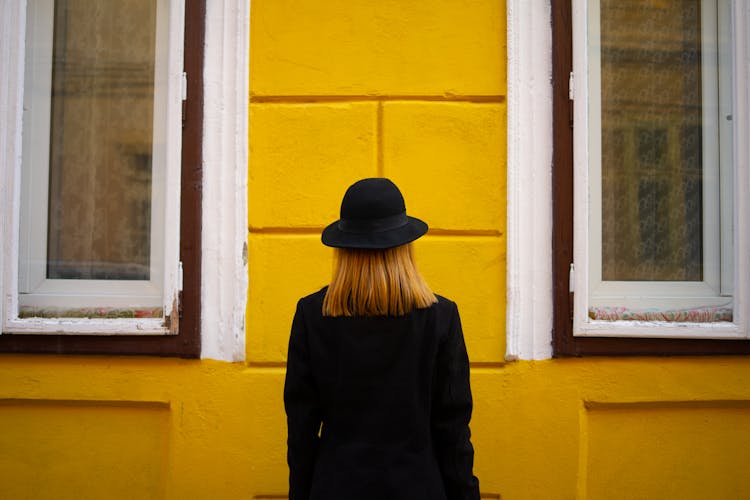 Portrait Of Woman Against Yellow Wall