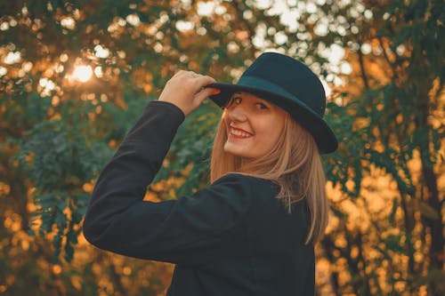 Woman Wearing Black Blazer and Hat Posing