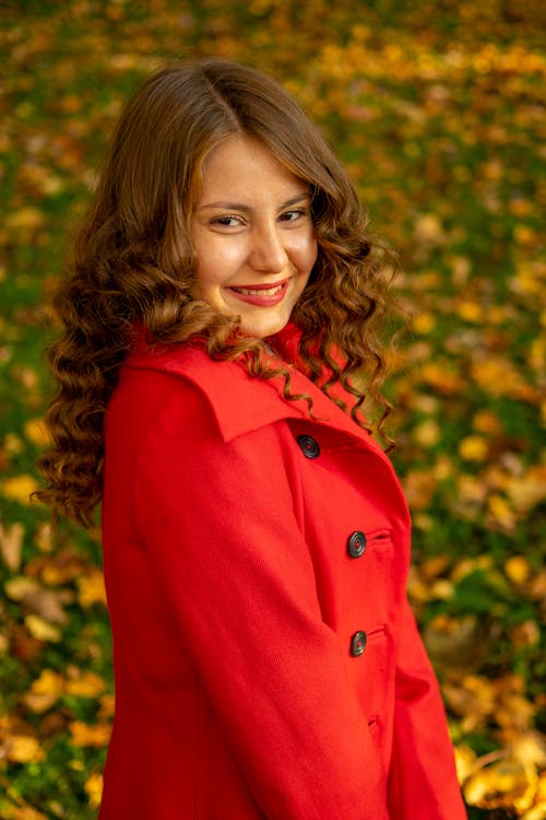 Free Close-Up Shot of a Pretty Woman in Red Coat Smiling Stock Photo