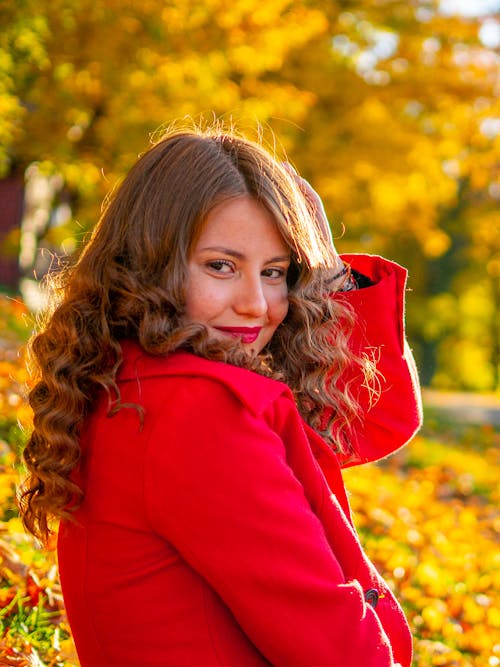 Free Close-Up Shot of a Pretty Woman in Red Coat Smiling Stock Photo