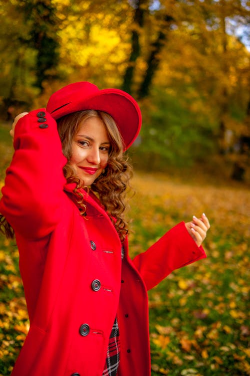Free A Pretty Woman in Red Coat Smiling Stock Photo