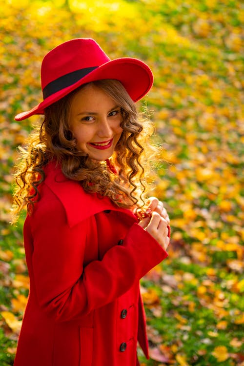 Free A Pretty Woman in Red Coat Smiling Stock Photo