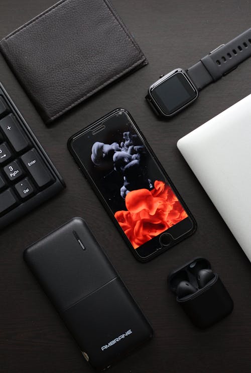 Free Modern Gadgets on a Black Surface Stock Photo