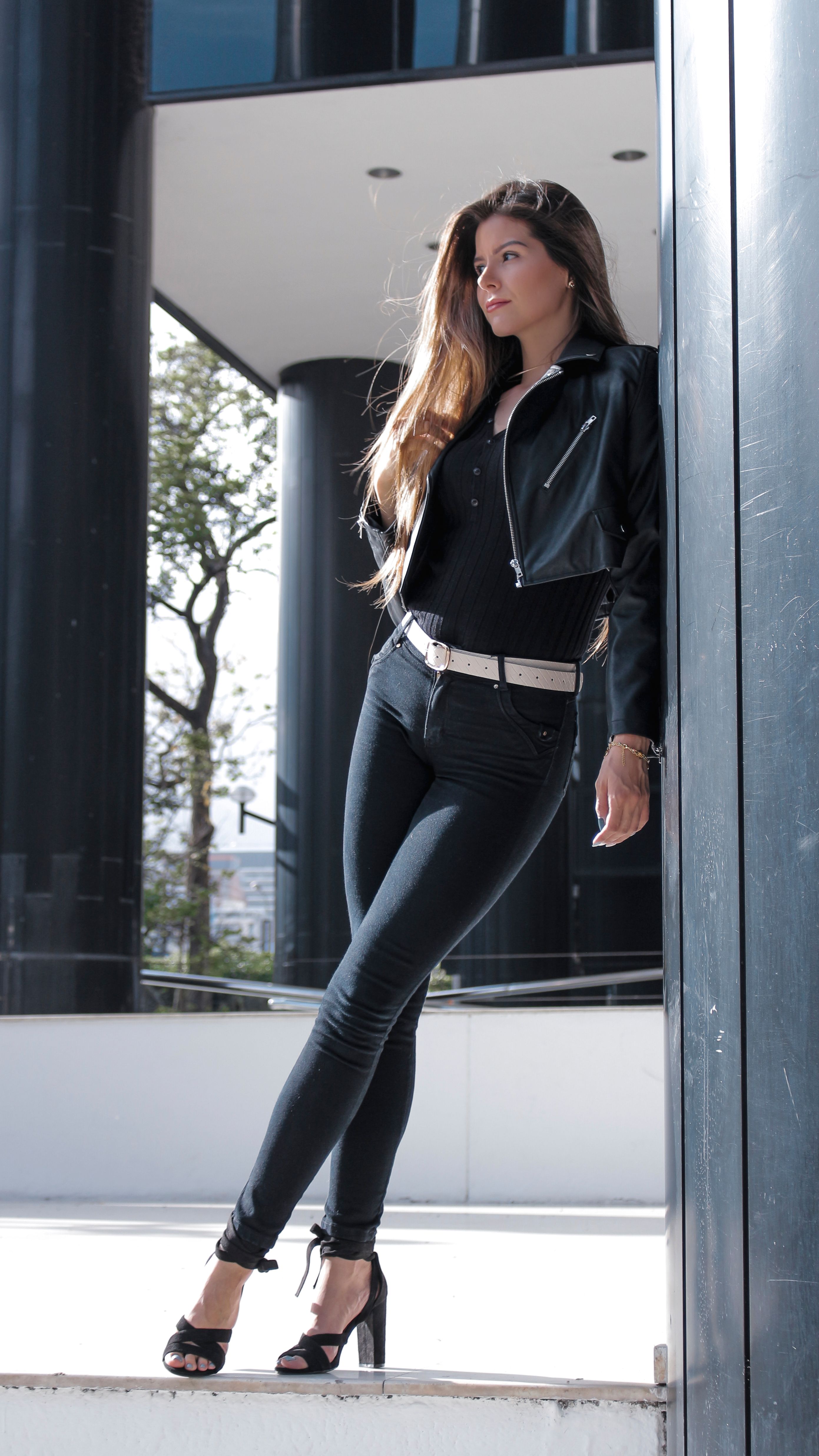 Woman in high-rise dark jeans with a burgundy wrap top