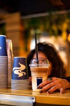 A woman reaches for a coffee cup indoors at a cozy Cyprus café. Vibrant atmosphere.