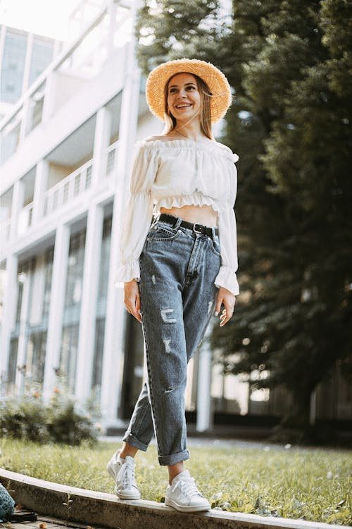 Smiling Woman Wearing Straw Hat in City