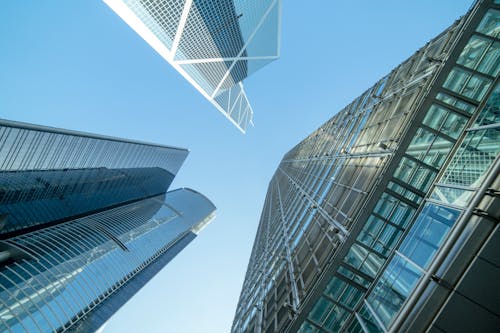 Low Angle Photography of Buildings Under Blue and White Sky