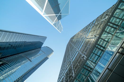 Modern skyscrapers captured from below, showcasing Hong Kong's urban architecture.