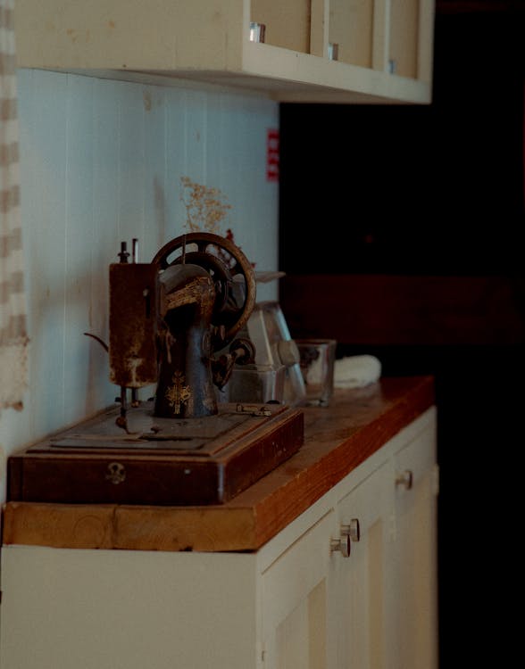 Old Sewing Machine on a Wooden Cupboard 