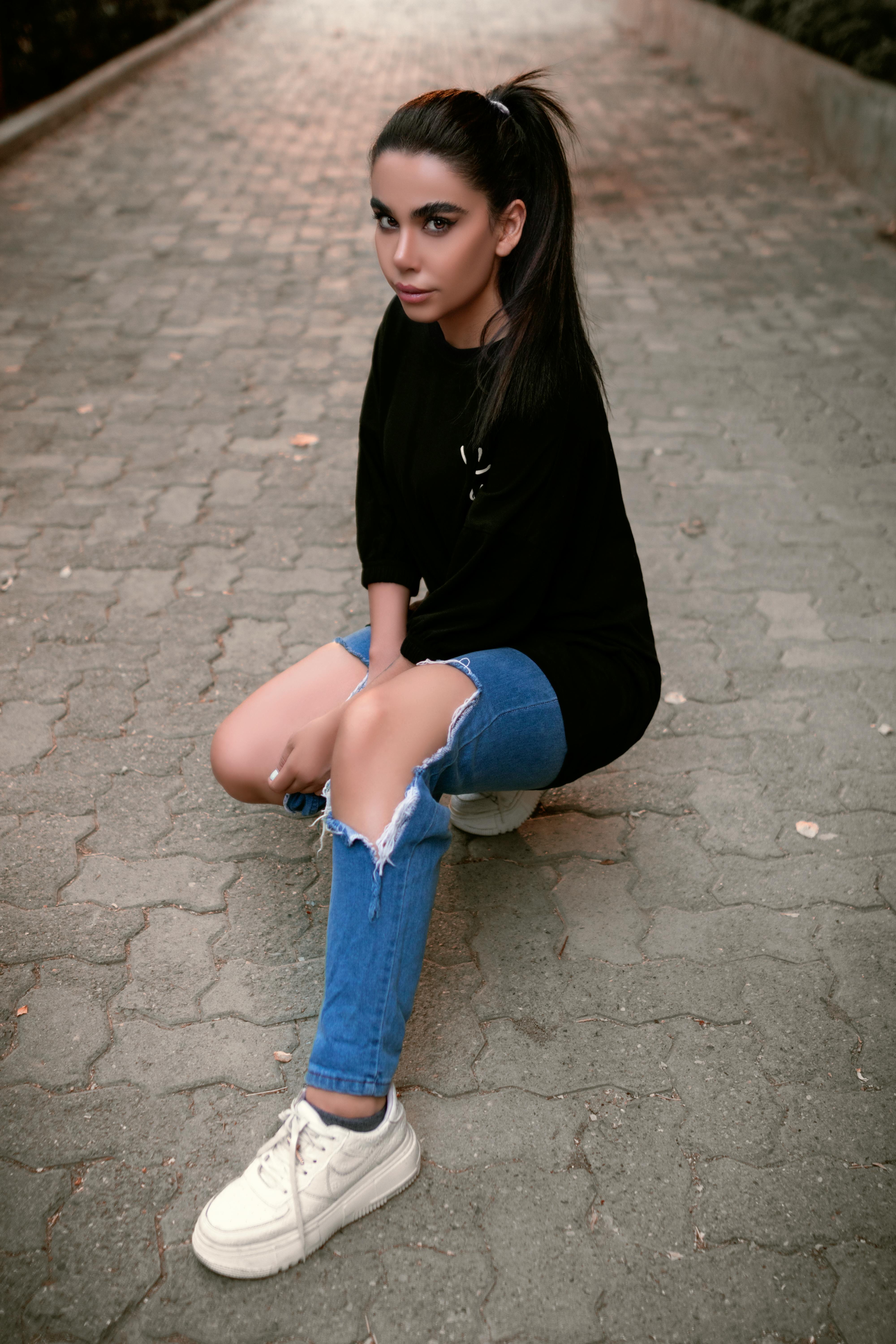 Woman in Black Shirt Posing Beautifully on the Street · Free Stock Photo