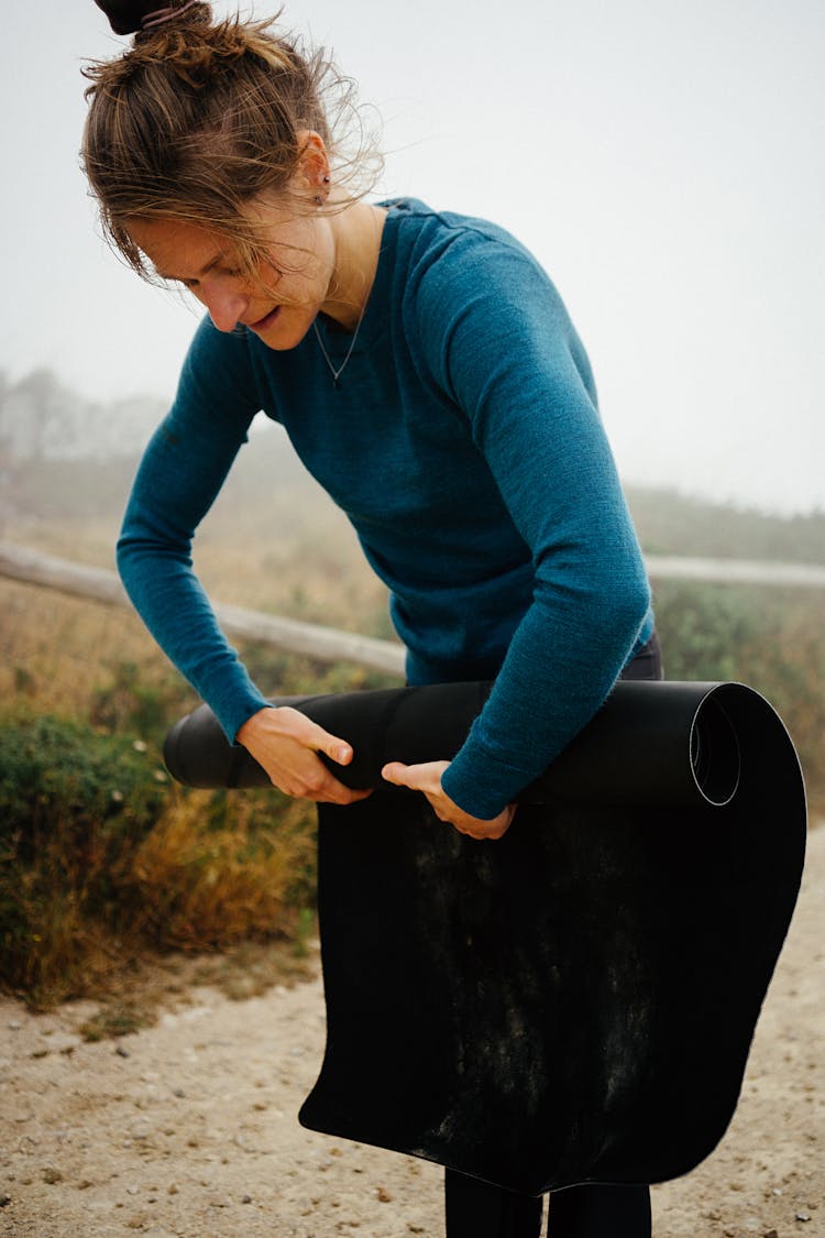 Woman Rolling Yoga Mat