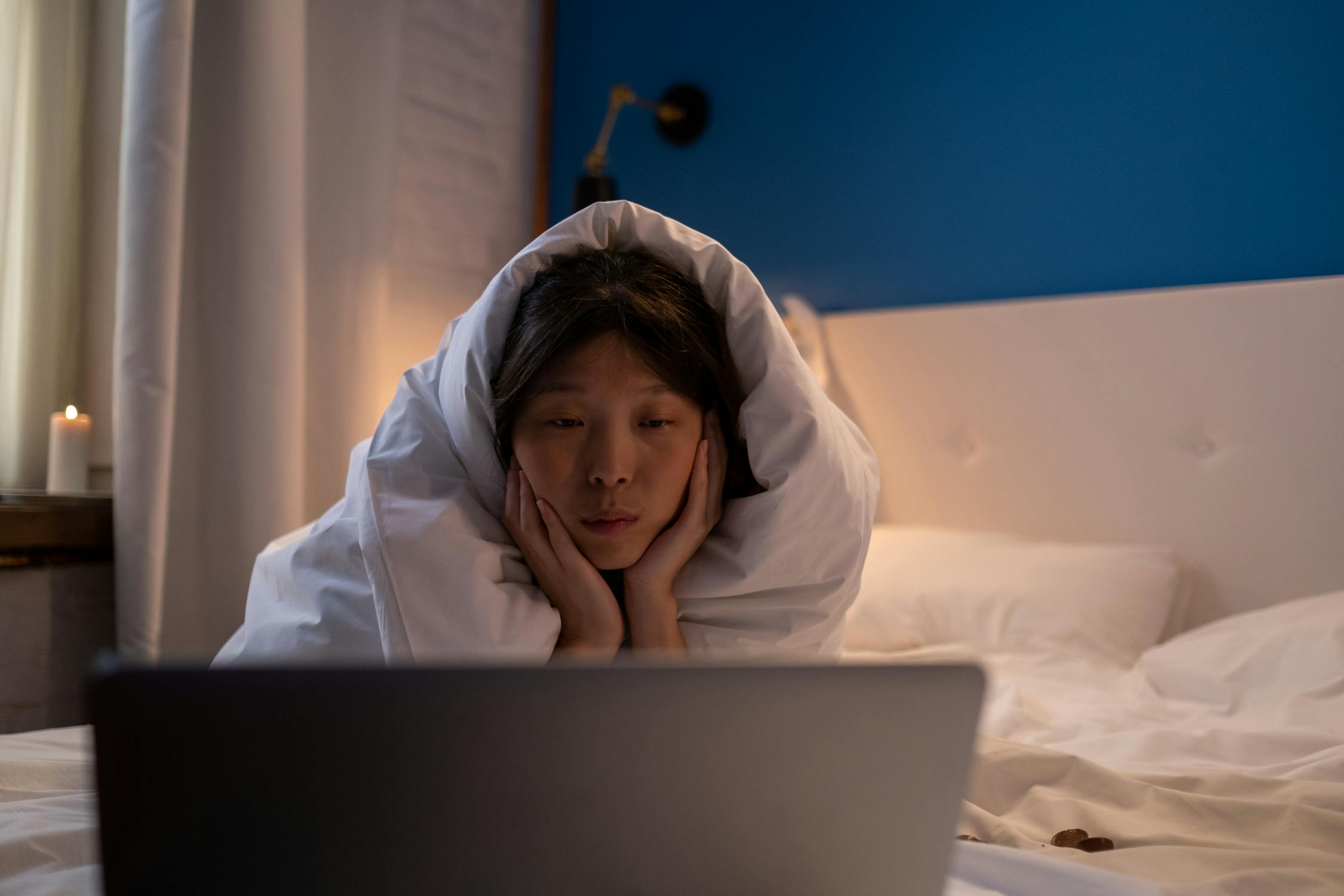 A girl watching a movie on a laptop
