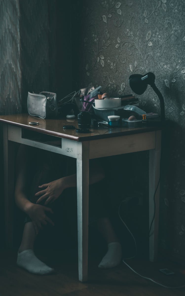 Person Sitting Under Table