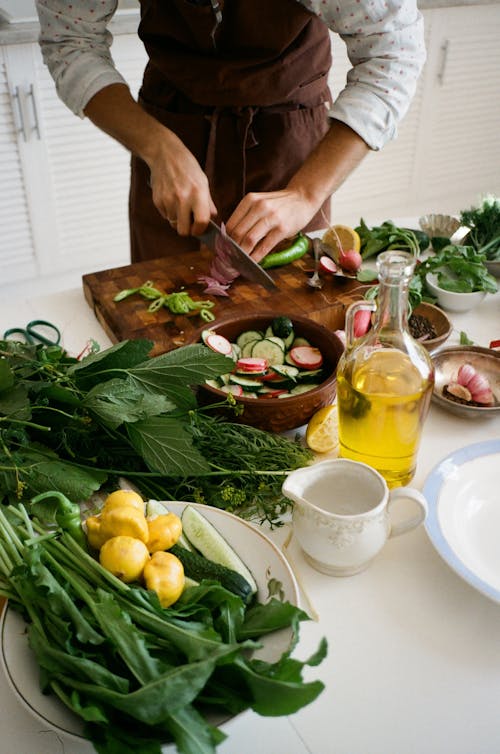 Free Person Slicing Vegetables on Chopping Board Stock Photo