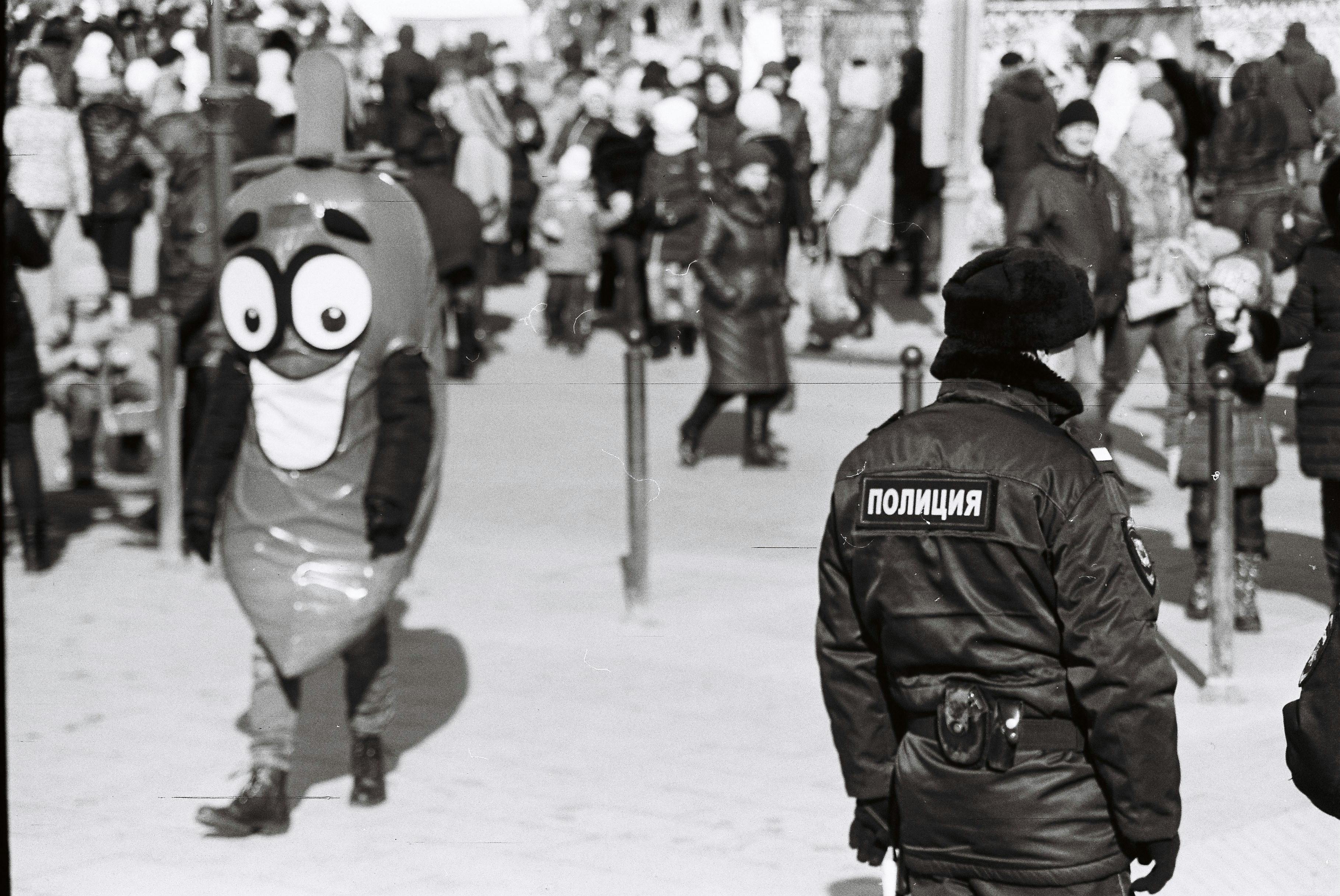 Grayscale Photo of Mascot Walking