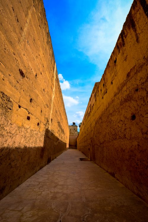 Free Explore the captivating ancient stone alleyway under the vibrant Marrakech sky. Stock Photo