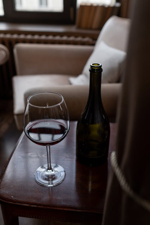 Glass of Wine and Bottle on Table