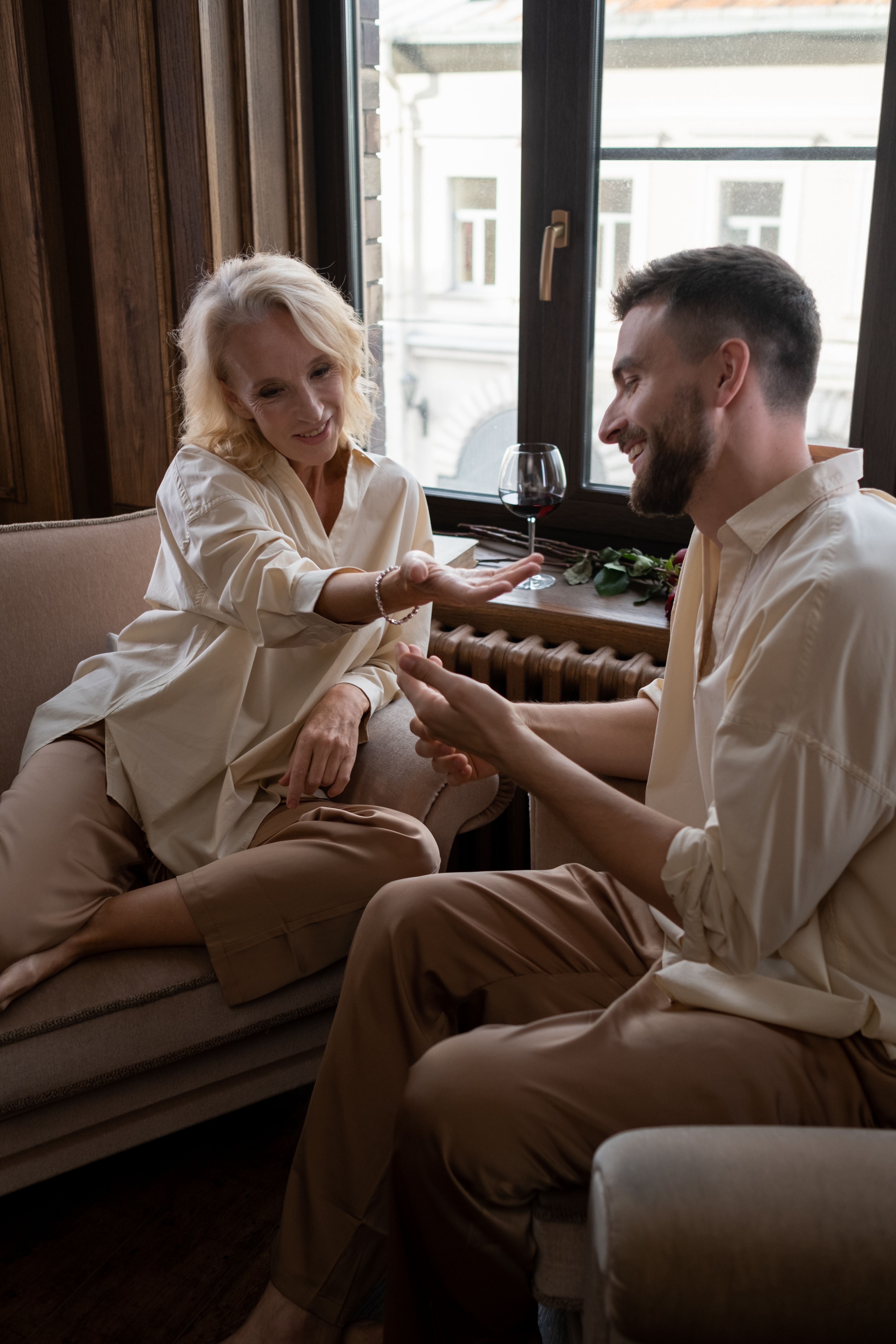 A mature couple enjoys a personal moment together in a cozy, stylish living room setting.