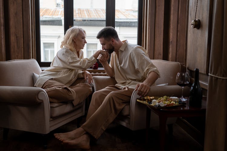 Man Kissing Hand Of Woman