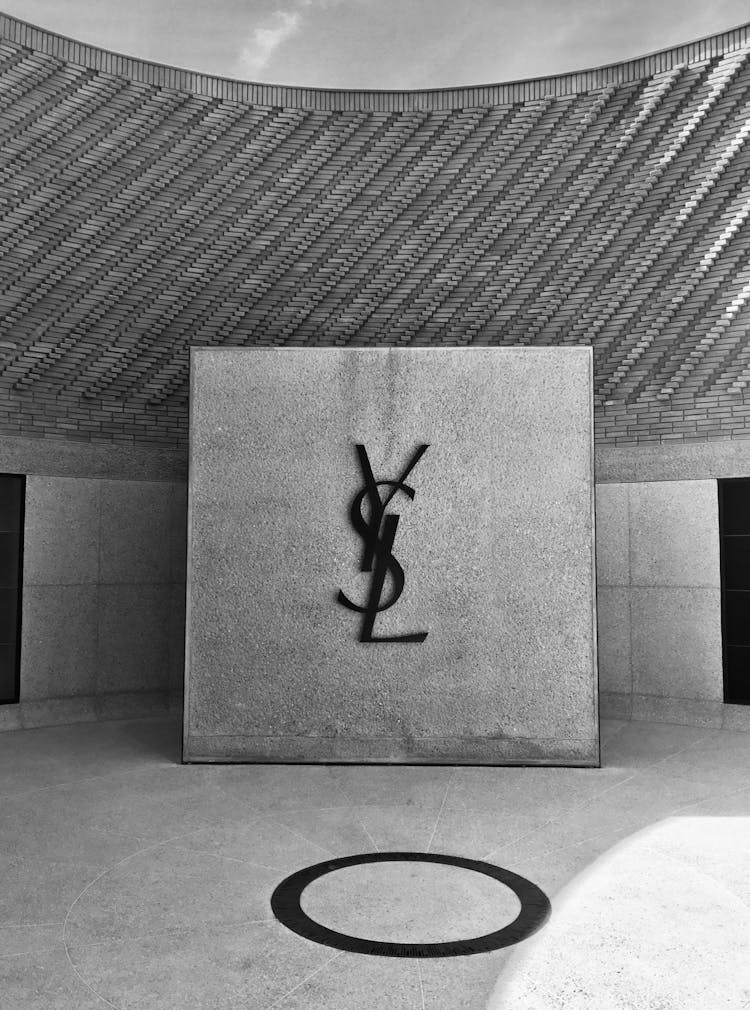 Brand Logo On Stonewall Inside The Yves Saint Laurent Museum In Grayscale Photography