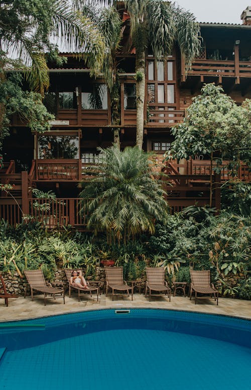 Free Woman in Bikini Relaxing by Pool in Tropical Resort in Bombinhas Stock Photo
