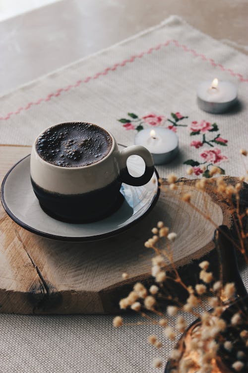 Free Close-Up Shot of a Cup of Black Coffee on a Saucer Stock Photo