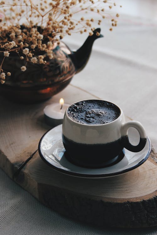 Close-Up Shot of a Cup of Black Coffee on a Saucer