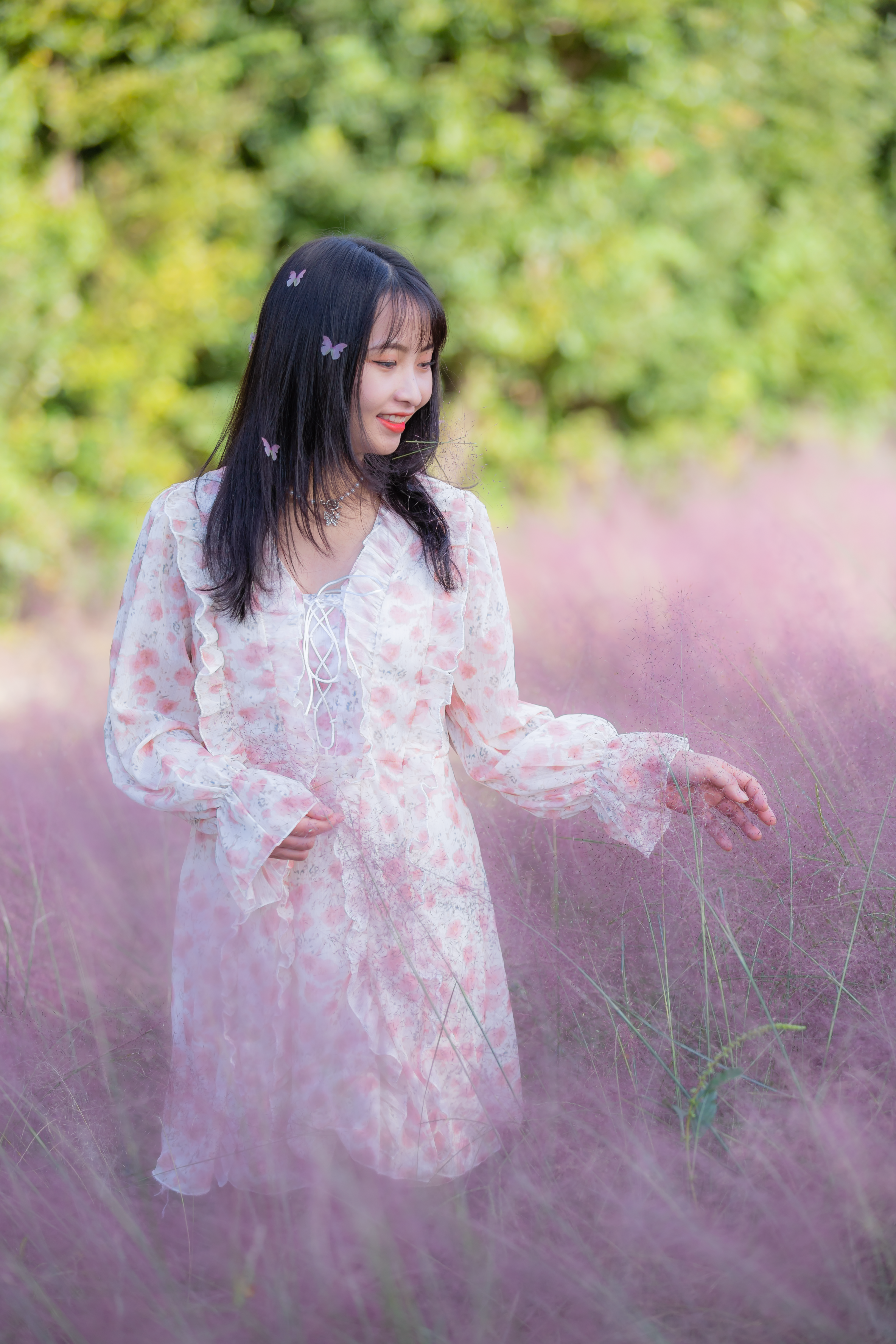Woman in Flower Printed Dress Standing in Grass Field · Free Stock Photo