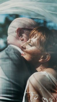 A touching moment between a couple on their wedding day outdoors.