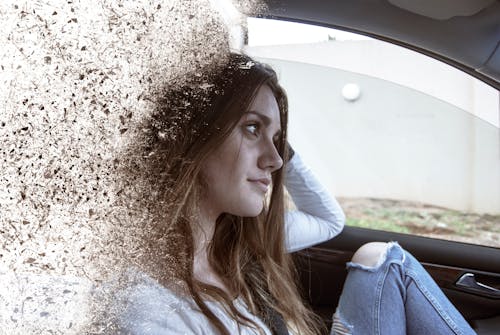 Woman Wearing Distress Blue Jeans Sitting on Vehicle Seat