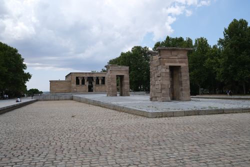 Free Historic Egyptian temple in Madrid, surrounded by lush greenery and a cloudy sky. Stock Photo