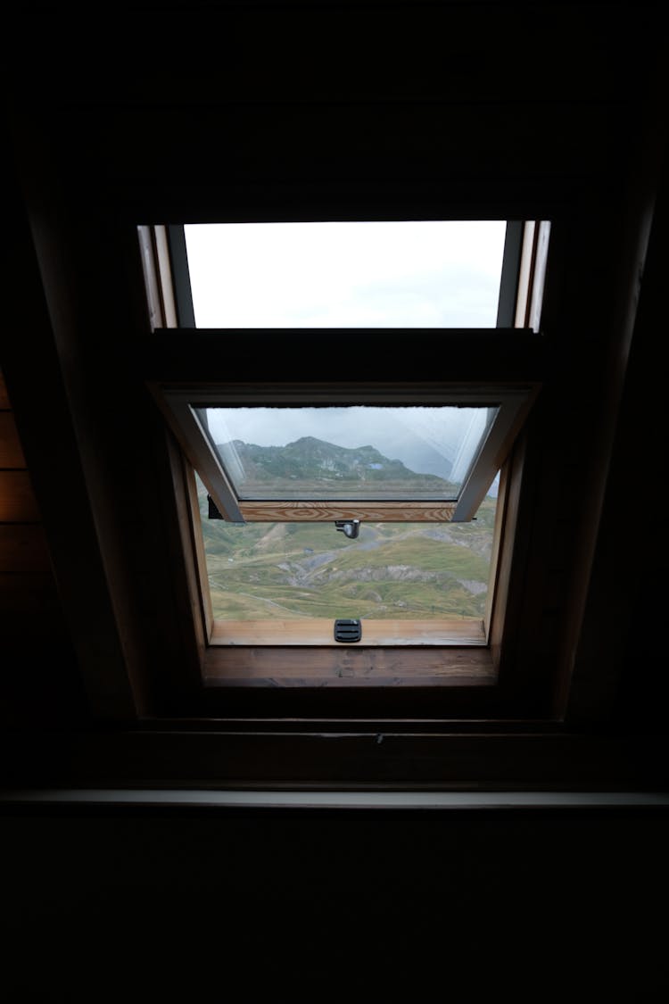 Opened Roof Window With Landscape