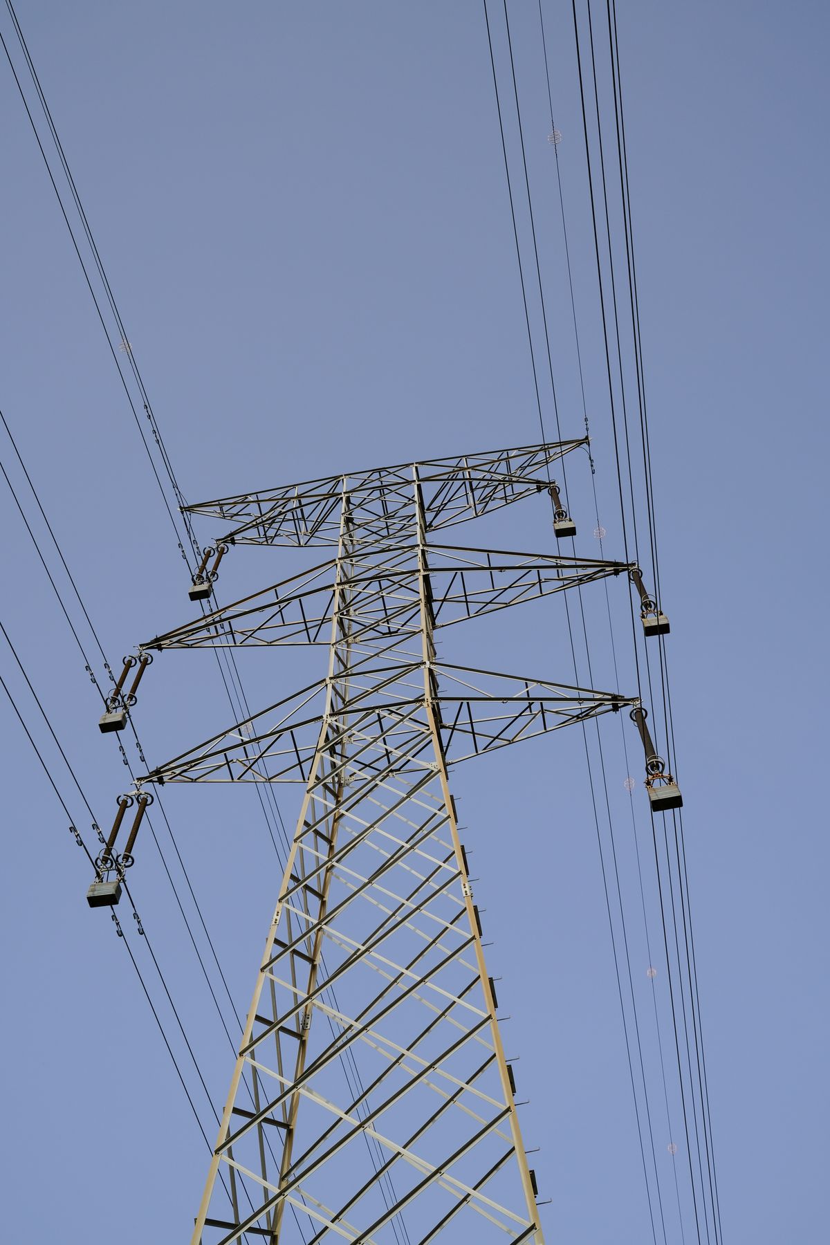 High-voltage transmission tower against a clear blue sky, a facility whose maintenance, settings and ratings records form the evidence behind an RSAW