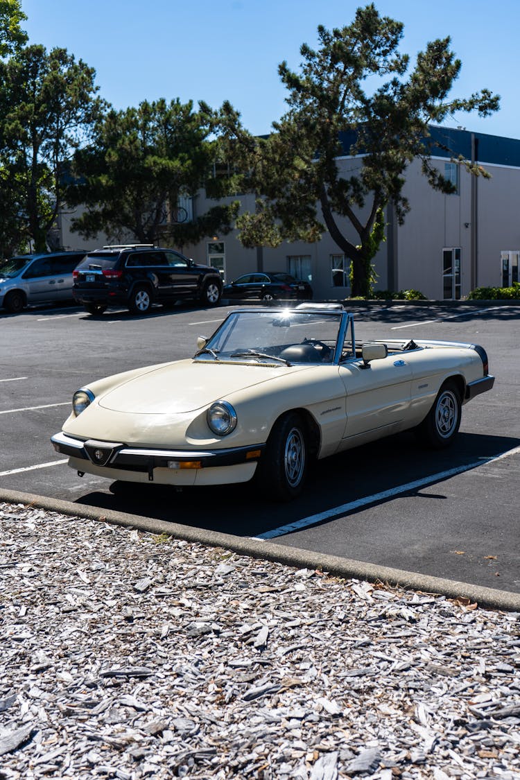 White Convertible Vintage Car At A Parking Lot