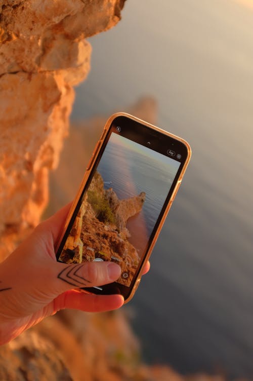 Free Close-Up Shot of a Person Taking Photo Using a Smartphone Stock Photo