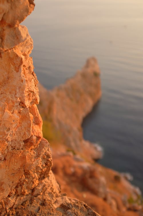 Brown Rock Formation Near Body of Water