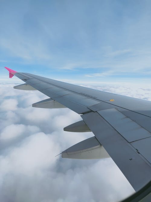Free  Gray Airplane Wing Under Blue Sky Stock Photo