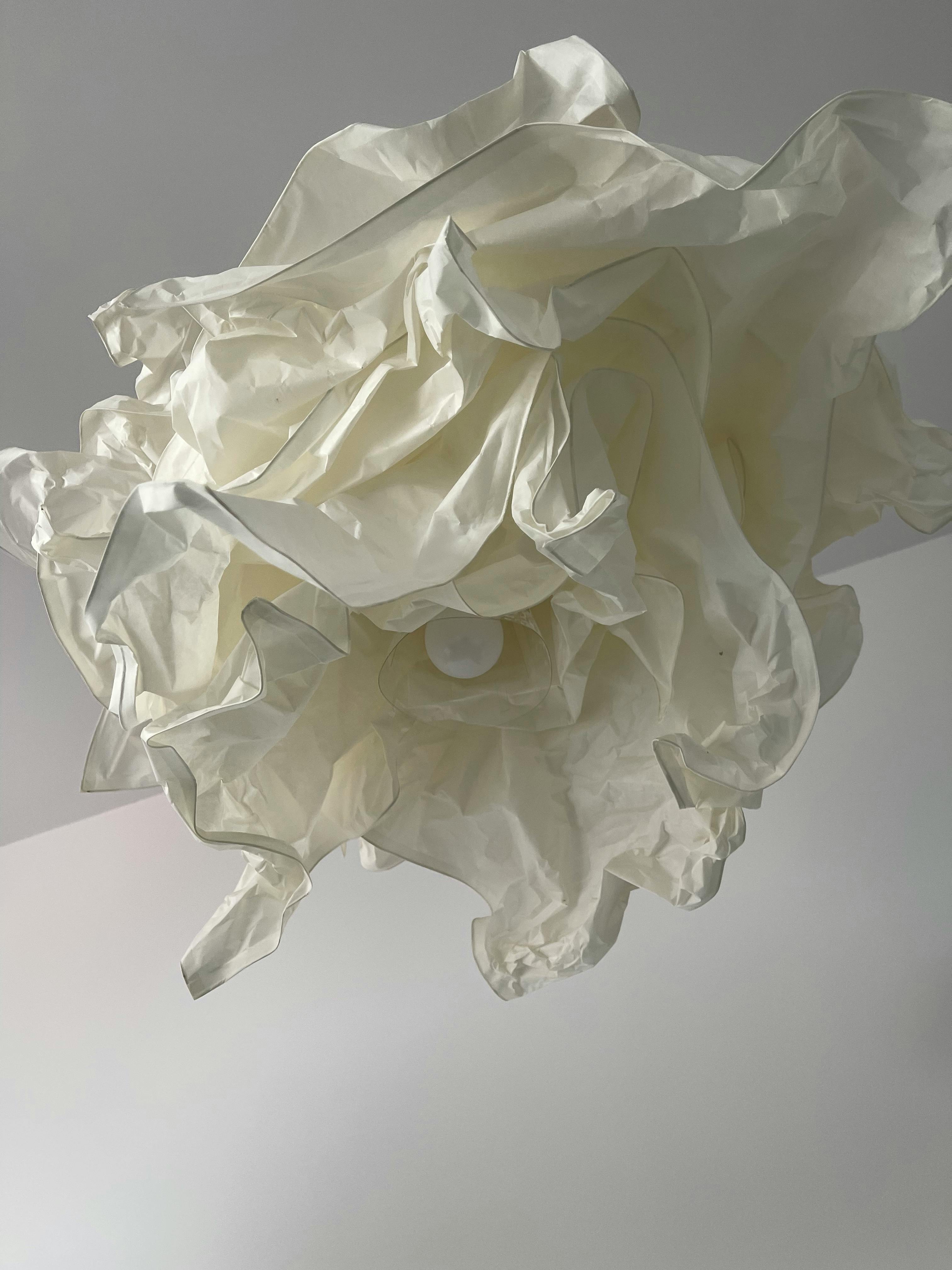 Abstract crumpled light fixture on a white ceiling, showcasing modern design.