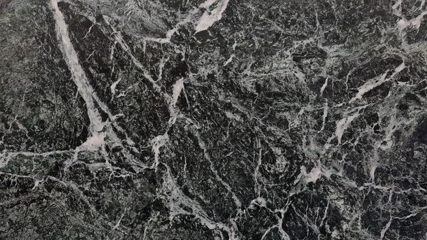 Close-up view of dark marble with intricate natural patterns and textures.