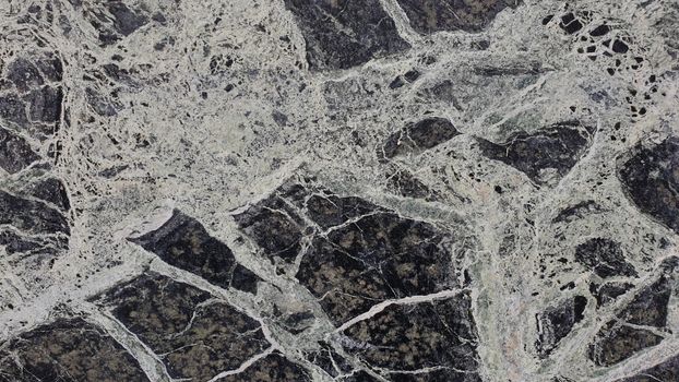 Close-up of a natural marble texture featuring intricate black and white patterns.