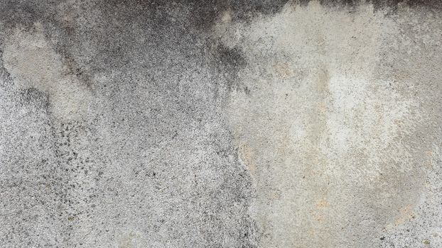 Grungy concrete wall texture with stains and decay, ideal for backgrounds.