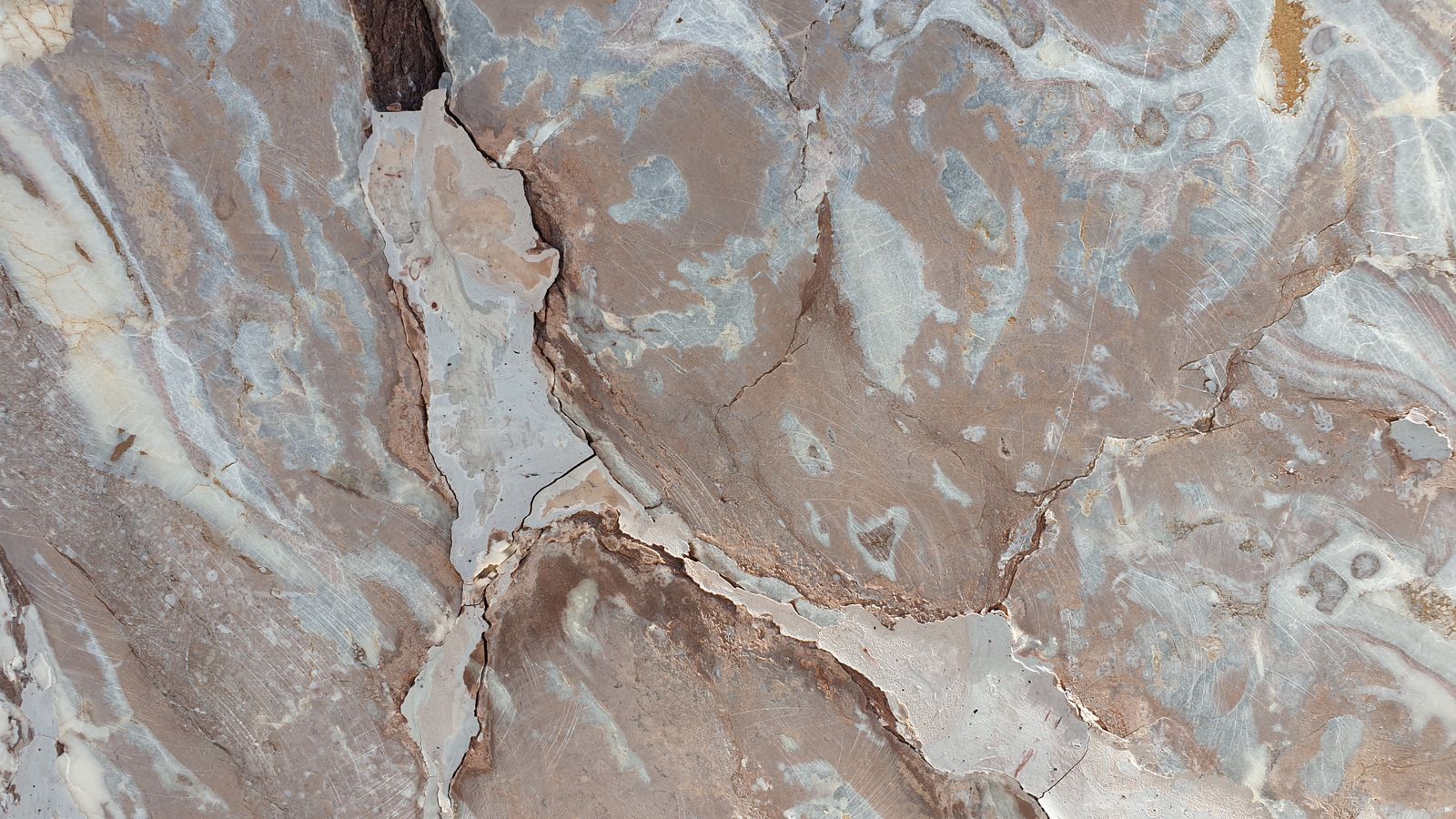 Polished slab of veined stone in rust, pewter and pale grey &mdash; photo by Krakograff Textures on Pexels