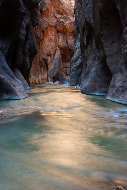 Photo of Body of Water Surrounded by Rock Formation