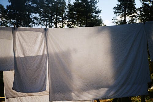 Free  Hanging White Blankets on Clothesline Stock Photo