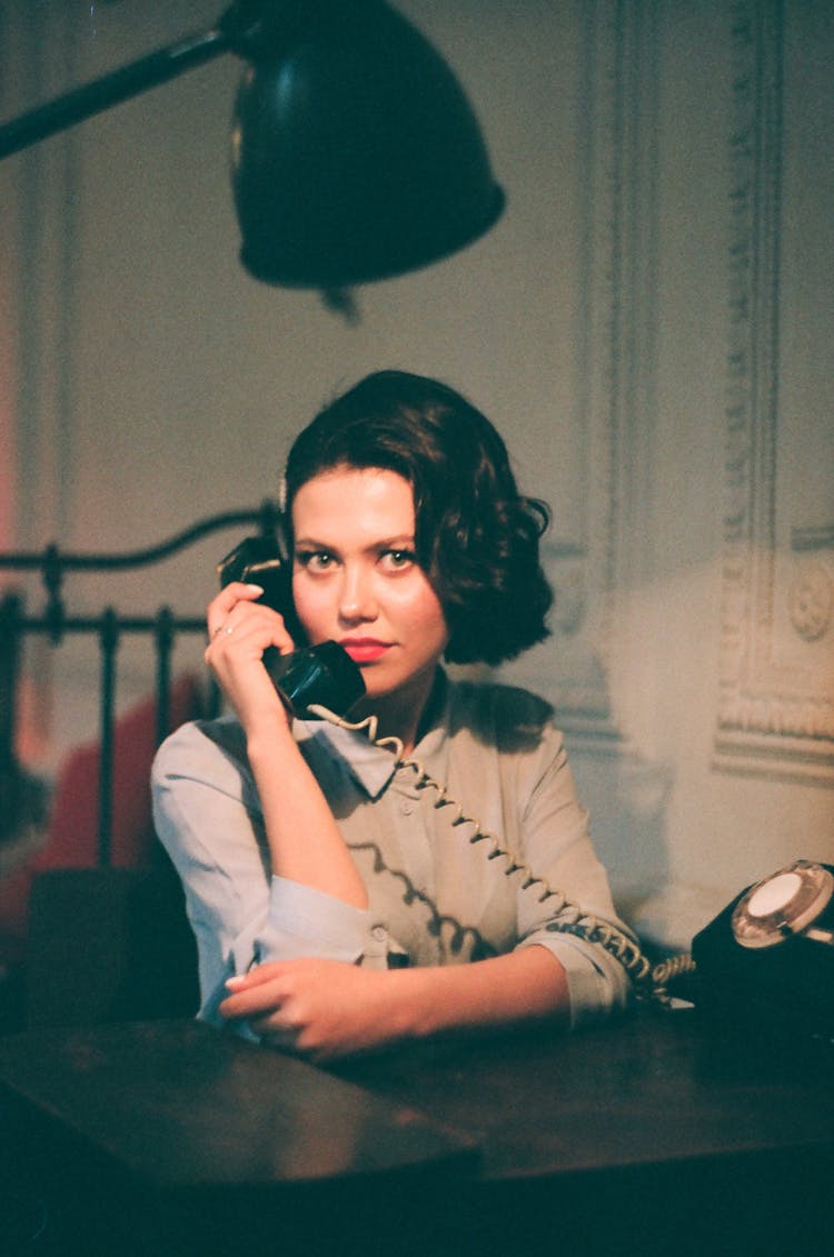 Portrait Of Black Haired Woman Holding Handset