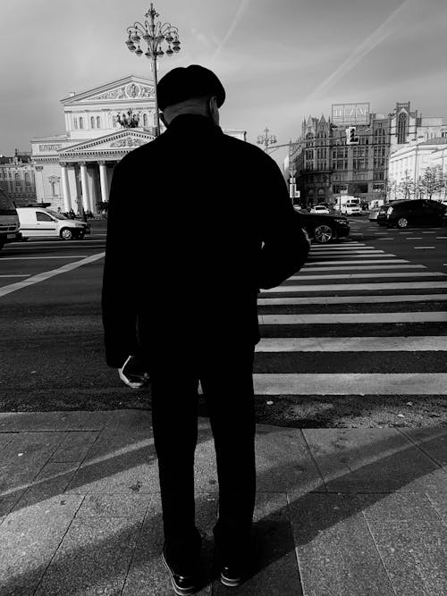 A Man Standing in Front of a Pedestrian Lane