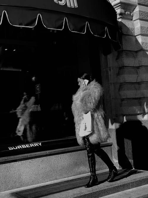 Grayscale Photography of Woman in Fur Coat Talking on the Phone